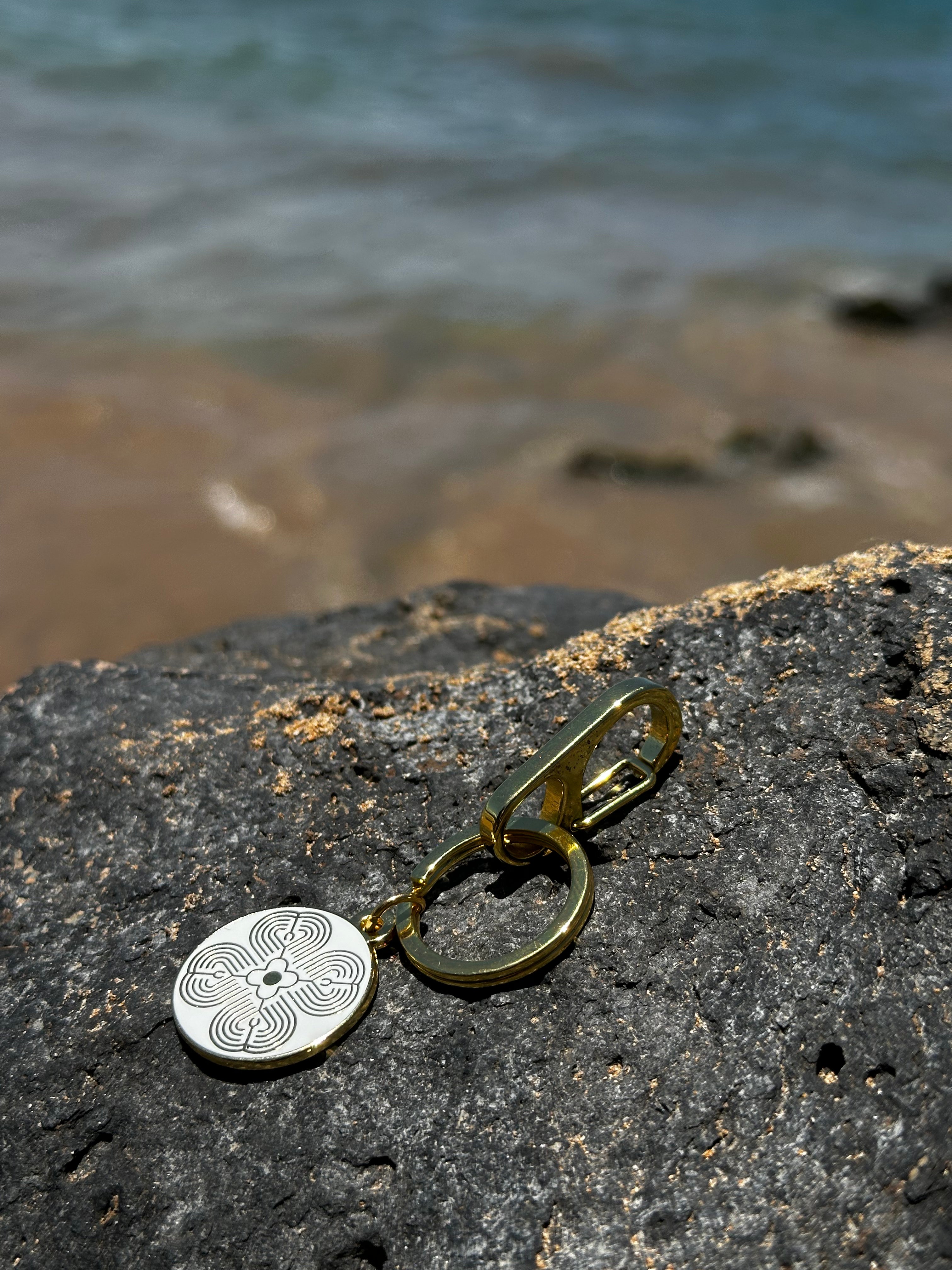 Atma keychain on the beach with ocean background 